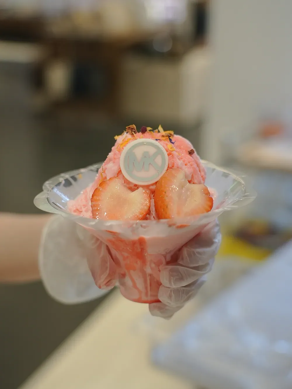 Pink shaved-ice dessert with a Michael Kors topper