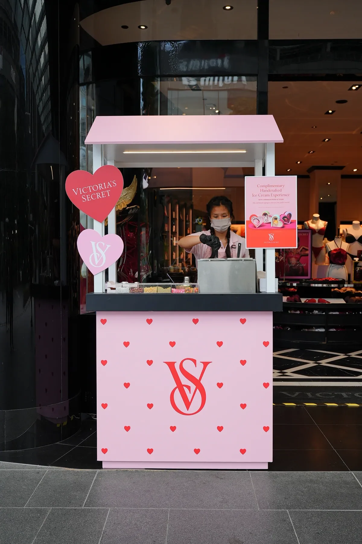 Victoria’s Secret pink dessert cart with a server