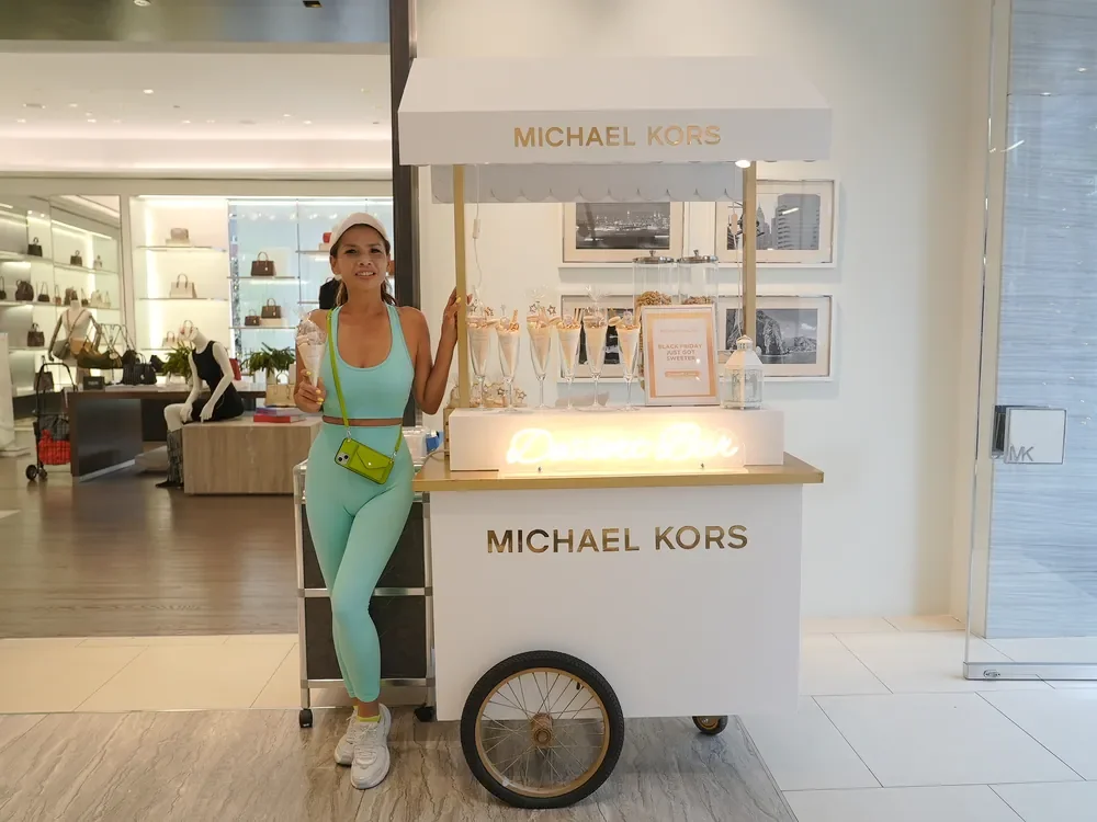 Guest beside the Michael Kors Dessert Bar cart